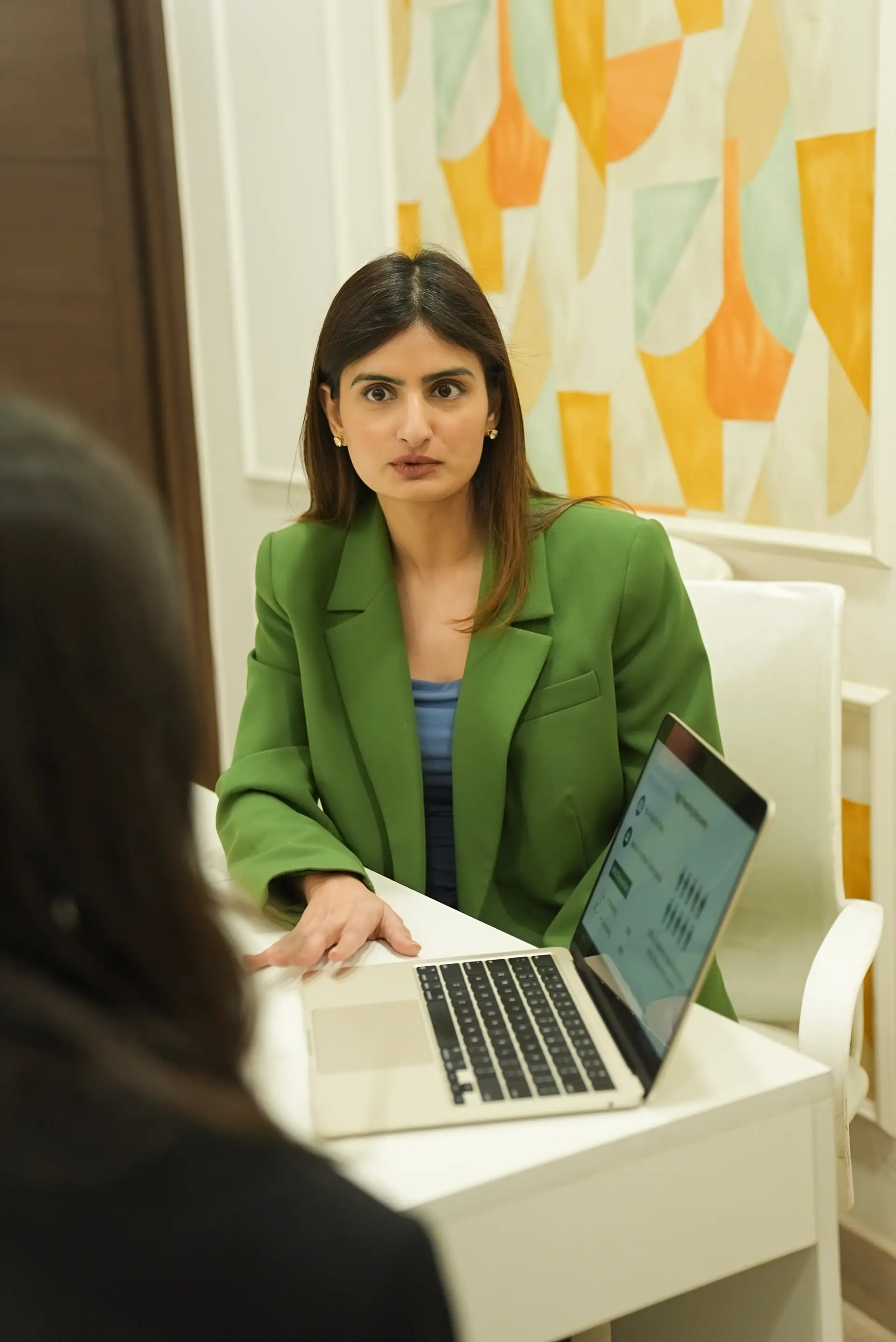 Friendly doctor answering patient questions beside a simple fertility report.
